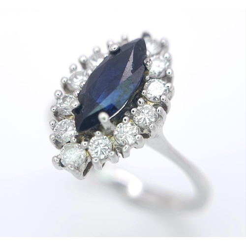 124 - AN 18K WHITE GOLD DIAMOND & SAPPHIRE MARQUISE SHAPE RING. 0.40CTW OF DIAMONDS AND A 1.20CT MARQUISE ... 