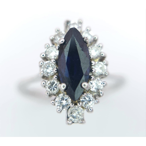 124 - AN 18K WHITE GOLD DIAMOND & SAPPHIRE MARQUISE SHAPE RING. 0.40CTW OF DIAMONDS AND A 1.20CT MARQUISE ... 