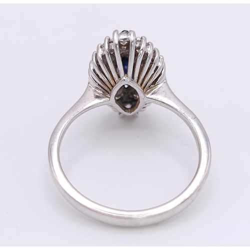 124 - AN 18K WHITE GOLD DIAMOND & SAPPHIRE MARQUISE SHAPE RING. 0.40CTW OF DIAMONDS AND A 1.20CT MARQUISE ... 