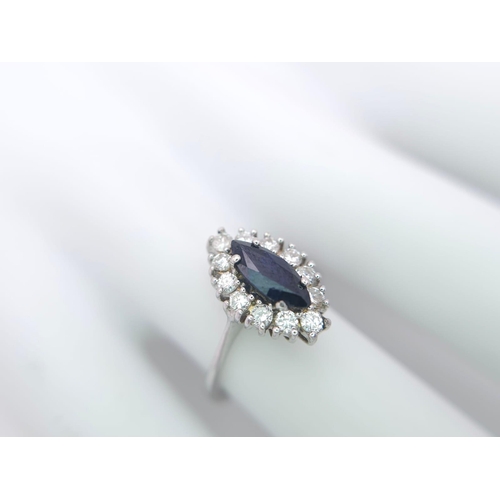 124 - AN 18K WHITE GOLD DIAMOND & SAPPHIRE MARQUISE SHAPE RING. 0.40CTW OF DIAMONDS AND A 1.20CT MARQUISE ... 