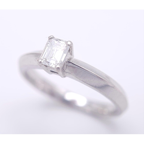 131 - AN 18K WHITE GOLD EMERALD CUT DIAMOND SOLITAIRE RING. 0.34CT. 3.6G. SIZE N.