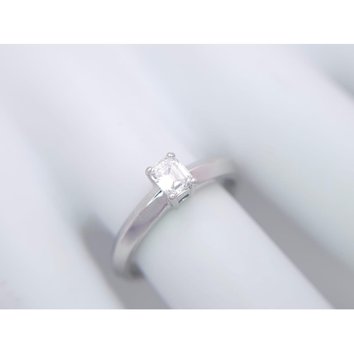 131 - AN 18K WHITE GOLD EMERALD CUT DIAMOND SOLITAIRE RING. 0.34CT. 3.6G. SIZE N.