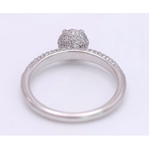 145 - A 14K WHITE GOLD DIAMOND DIAMOND HALO RING WITH FULL SET SHOULDERS AND COLLET. 1.10CT. 2.9G. SIZE M ... 