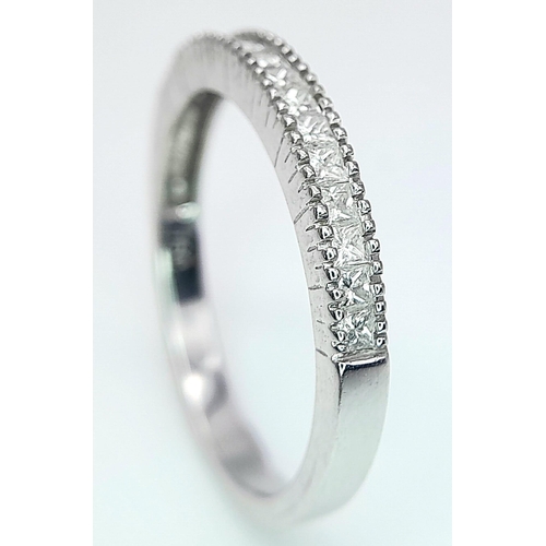 207 - AN 18K WHITE GOLD DIAMOND SET BAND RING - PRINCESS CUTS. 0.50CTW. 2.8G. SIZE P 1/2.