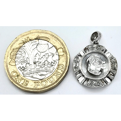 260 - A VERY CUTE 18K WHITE GOLD DIAMOND SET PENDANT WITH SPINNING DOG IN THE CENTRE! 2.2G. 2CM.