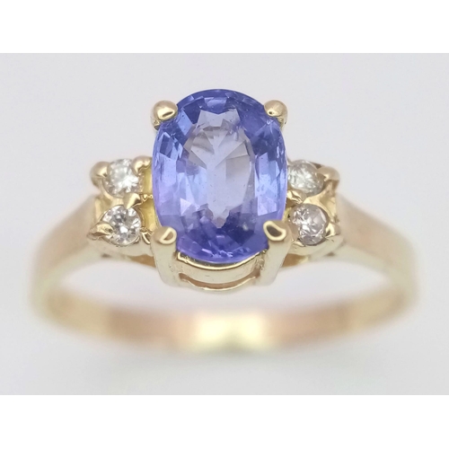 291 - A 14K YELLOW GOLD DIAMOND & BLUE STONE RING -(PROBABLY) TANZANITE. 1.9G. SIZE L.