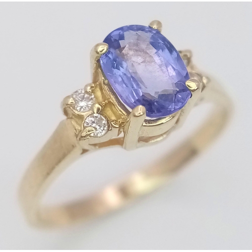 291 - A 14K YELLOW GOLD DIAMOND & BLUE STONE RING -(PROBABLY) TANZANITE. 1.9G. SIZE L.