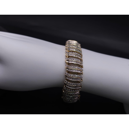 5 - A BEAUTIFUL  HEAD-TURNING 14K YELLOW GOLD DIAMOND TENNIS BRACELET WITH A MIXTURE OF ROUND AND BAGUET... 