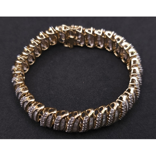 5 - A BEAUTIFUL  HEAD-TURNING 14K YELLOW GOLD DIAMOND TENNIS BRACELET WITH A MIXTURE OF ROUND AND BAGUET... 