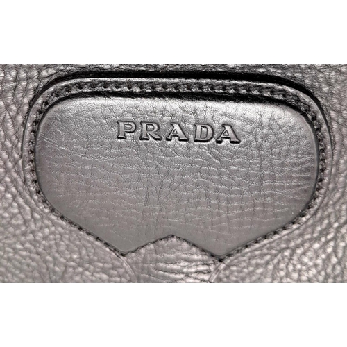 192 - A Prada Black Leather Crossbody Satchel Bag. Textured exterior with buckled flap. Spacious leather a... 