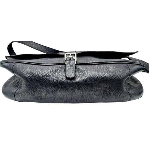 192 - A Prada Black Leather Crossbody Satchel Bag. Textured exterior with buckled flap. Spacious leather a... 