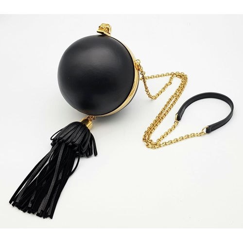 220 - An Alexander Mcqueen Skull Ball Clutch Bag. Black leather exterior with gold tone hardware. Detachab... 