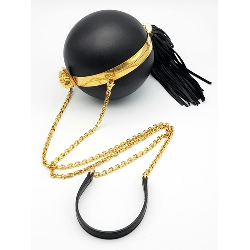 220 - An Alexander Mcqueen Skull Ball Clutch Bag. Black leather exterior with gold tone hardware. Detachab... 