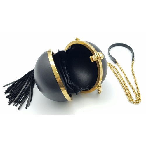 220 - An Alexander Mcqueen Skull Ball Clutch Bag. Black leather exterior with gold tone hardware. Detachab... 