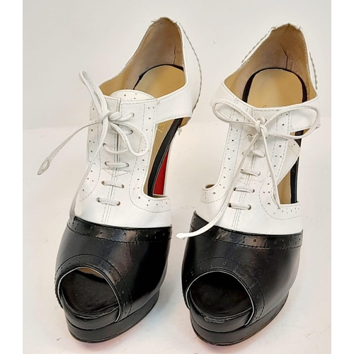 1805 - A Pair of Louboutin high heels in black and white leather. Lightly used. Size 40.