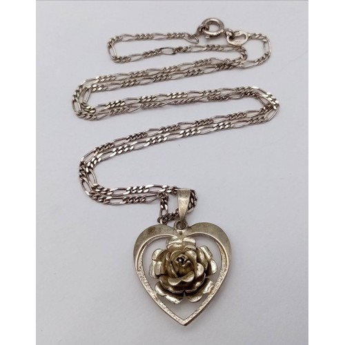 1392 - A vintage sterling silver floral heart pendant on 925 silver figaro chain. Total weight 6.5G. Total ... 