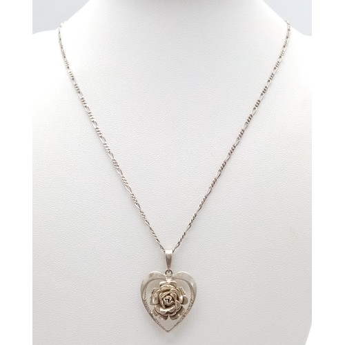 1392 - A vintage sterling silver floral heart pendant on 925 silver figaro chain. Total weight 6.5G. Total ... 