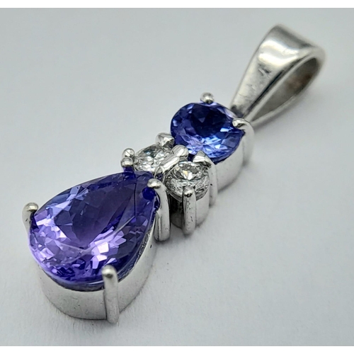 242 - A Platinum, Tanzanite and Diamond Pendant. A beautiful teardrop blue tanzanite with round cut diamon... 