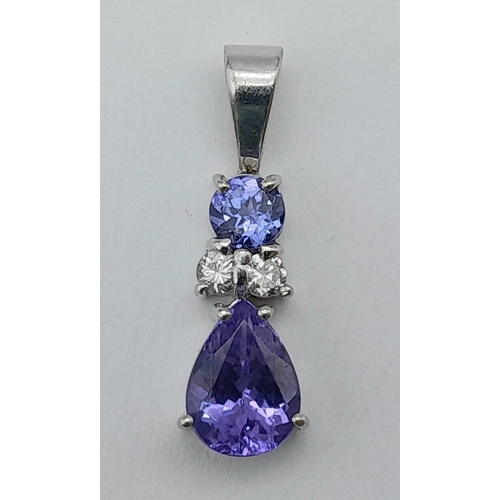 242 - A Platinum, Tanzanite and Diamond Pendant. A beautiful teardrop blue tanzanite with round cut diamon... 