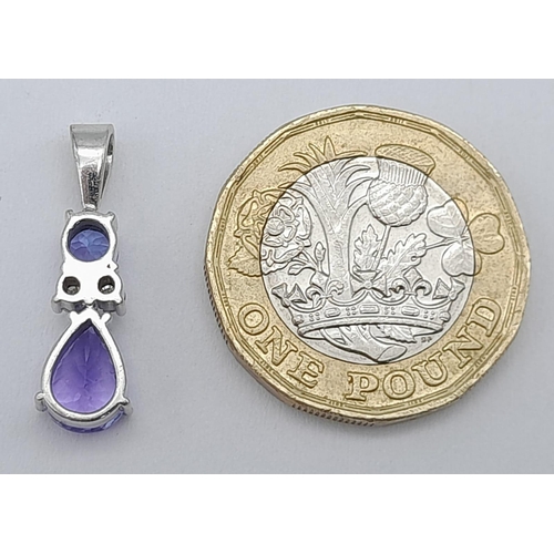 242 - A Platinum, Tanzanite and Diamond Pendant. A beautiful teardrop blue tanzanite with round cut diamon... 