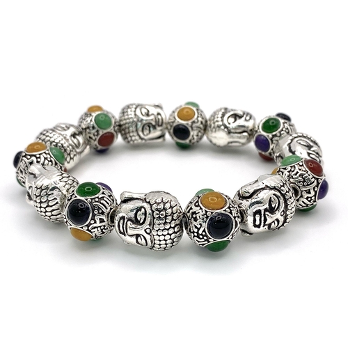 405 - A Tibetan Silver and Multi Coloured Jade Bracelet. Deity shaped links with jade cabochon spaces. Exp... 