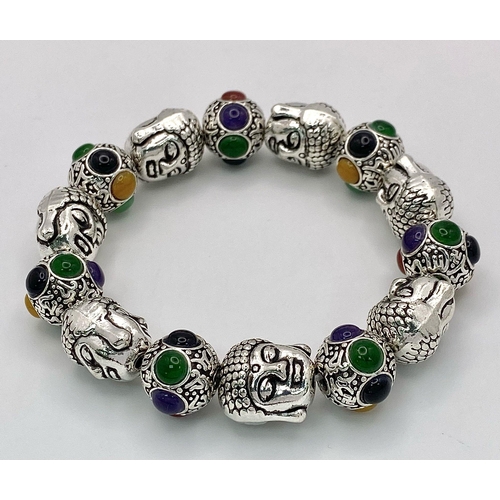 405 - A Tibetan Silver and Multi Coloured Jade Bracelet. Deity shaped links with jade cabochon spaces. Exp... 