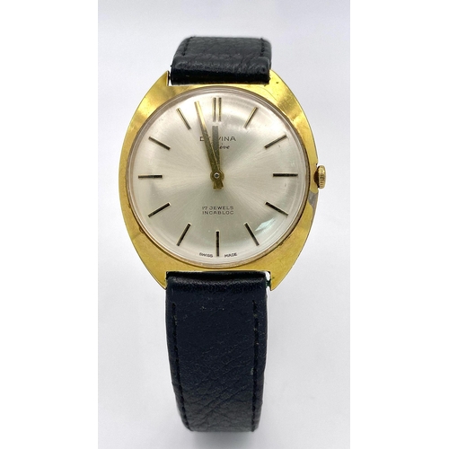 423 - A Vintage 17 Jewels Delvina Mechanical Gents Watch. Black leather strap. Gilded case - 36mm. Silver ... 