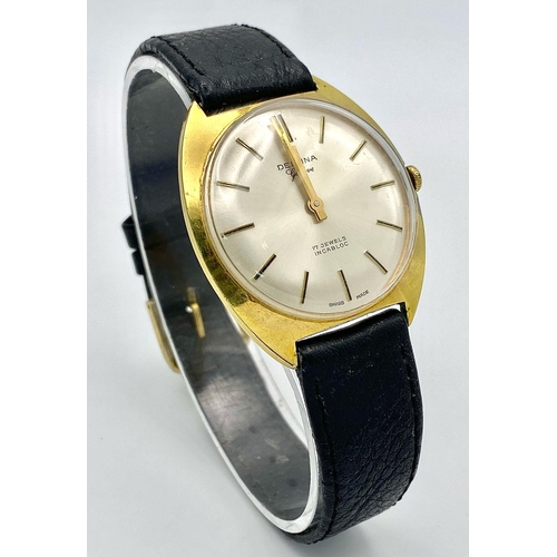 423 - A Vintage 17 Jewels Delvina Mechanical Gents Watch. Black leather strap. Gilded case - 36mm. Silver ... 