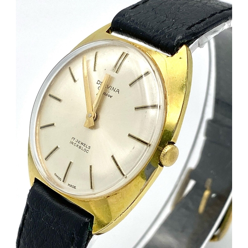 423 - A Vintage 17 Jewels Delvina Mechanical Gents Watch. Black leather strap. Gilded case - 36mm. Silver ... 