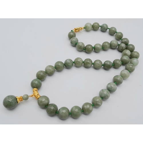 435 - A Celadon Jade Bead Necklace with Drop Pendant. Rich 12mm jade beads. Gilded drop pendant - 4cm. Nec... 