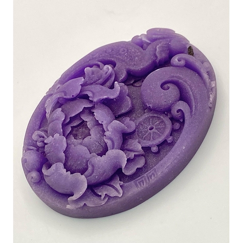 472 - A Beautiful Dark Lavender Jade Oval Pendant. Decorative floral and bird decoration. 6cm.