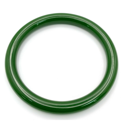 544 - A Spinach Green Chinese Thin Jade Bangle. 7mm width. 60mm inner diameter.