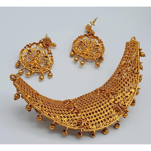 125 - A South Indian traditional “Temple Jewellery” consisting of a necklace and matching earrings in an a... 