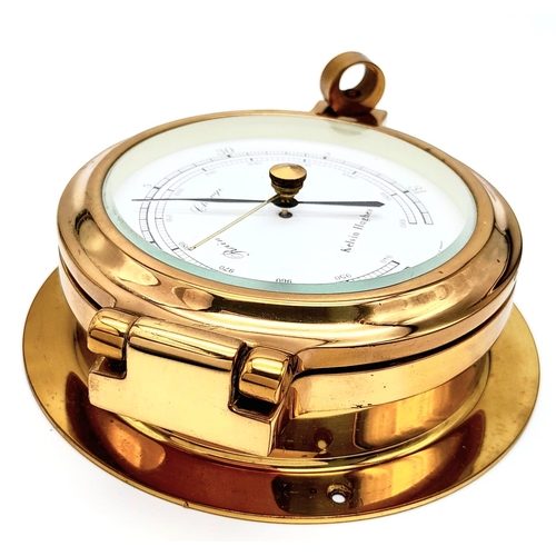 188 - A Nautical, polished brass, KELVIN HUGHES barometer, having the shape of a ship-cabin’s porthole, re... 