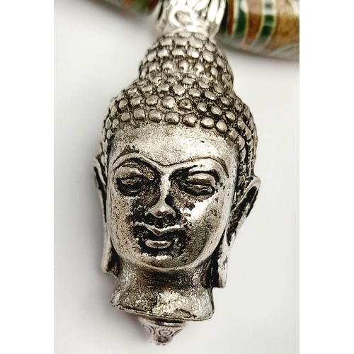 202 - A Tibetan silver, Buddhist, necklace and earrings set with light coloured, three eyed, agate, DZI la... 