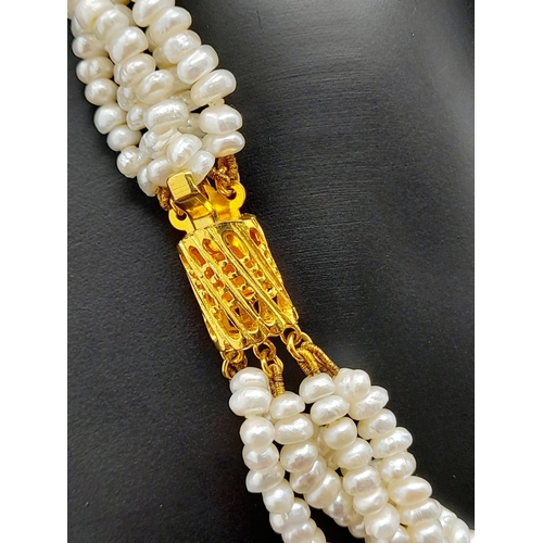 181 - A vintage, five row, natural, white pearl necklace, with a statement gold plated clasp. Length: 42 c... 