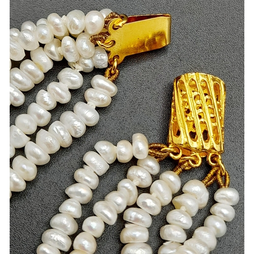 181 - A vintage, five row, natural, white pearl necklace, with a statement gold plated clasp. Length: 42 c... 