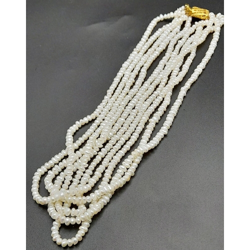 181 - A vintage, five row, natural, white pearl necklace, with a statement gold plated clasp. Length: 42 c... 