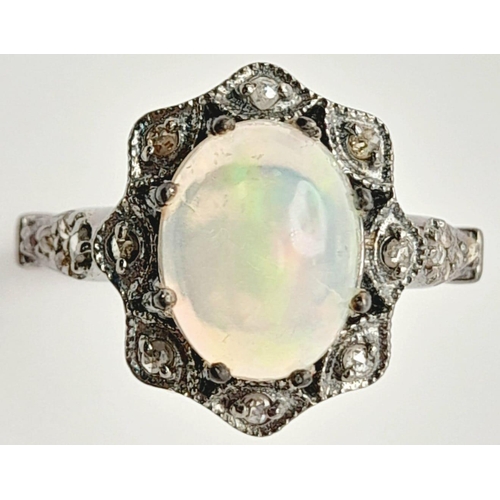 500 - An Ethiopian Opal Ring with Rose Cut diamond Surround and Accents. Set in 925 Sterling silver. Opal ... 