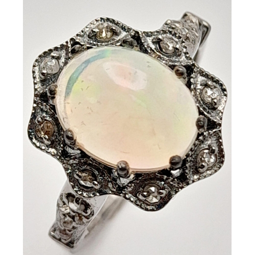 500 - An Ethiopian Opal Ring with Rose Cut diamond Surround and Accents. Set in 925 Sterling silver. Opal ... 