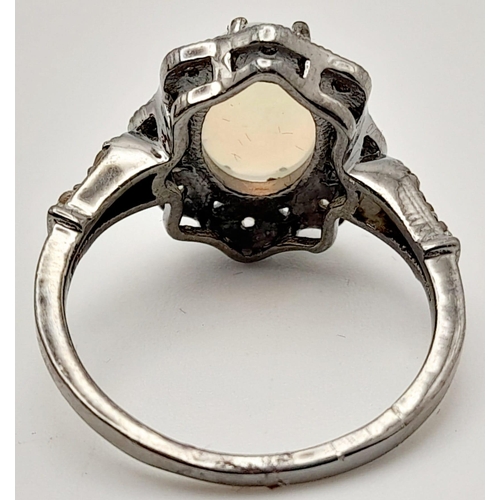 500 - An Ethiopian Opal Ring with Rose Cut diamond Surround and Accents. Set in 925 Sterling silver. Opal ... 