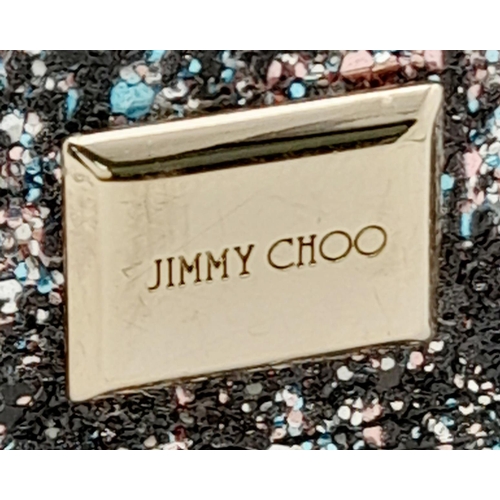 143 - A Jimmy Choo 'Leni' Glitter Crossbody Bag. Black leather and blue, pink and black glitter exterior w... 