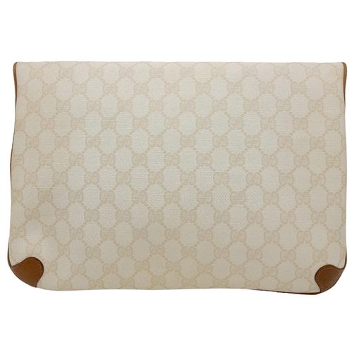 150 - A Gucci Ivory GG Monogram Clutch Bag. Leather exterior with brown trim, gold and silver-toned GG, an... 