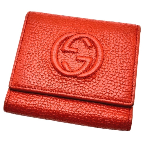 199 - A Gucci Red Trifold Wallet. Leather exterior with the GG logo and press stud closure. Red leather in... 