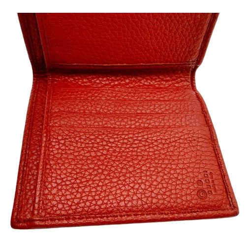 199 - A Gucci Red Trifold Wallet. Leather exterior with the GG logo and press stud closure. Red leather in... 