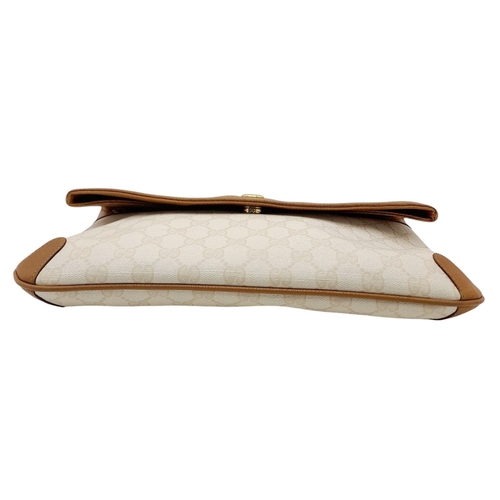 150 - A Gucci Ivory GG Monogram Clutch Bag. Leather exterior with brown trim, gold and silver-toned GG, an... 