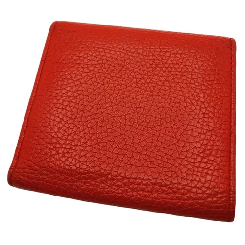 199 - A Gucci Red Trifold Wallet. Leather exterior with the GG logo and press stud closure. Red leather in... 