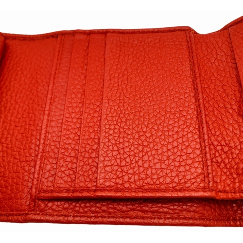 199 - A Gucci Red Trifold Wallet. Leather exterior with the GG logo and press stud closure. Red leather in... 