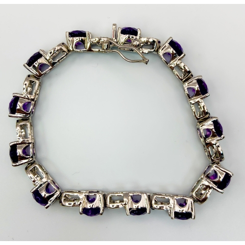 305 - An Amethyst & Sapphire Tennis Bracelet. Set in 925 Sterling silver. 33ctw. W- 24g. 18cm.