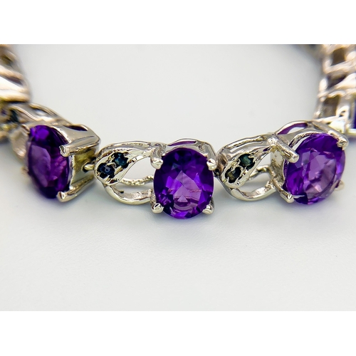 305 - An Amethyst & Sapphire Tennis Bracelet. Set in 925 Sterling silver. 33ctw. W- 24g. 18cm.